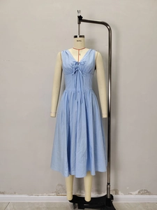 Elegant light blue V-neck midi dress with waist tie and bow detail for summer