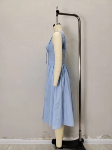 Slim fit light blue V-neck dress with corset waist and tie details on a fashion mannequin
