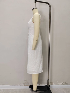 Detail of white sleeveless midi dress with delicate eyelet embroidery and slim silhouette