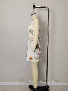 White sleeveless A-line mini dress with marine life prints and striped hem detail