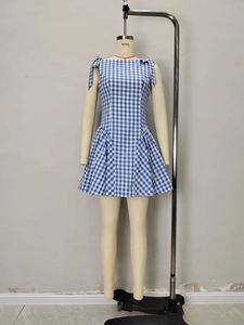 Blue and white gingham dress with bow shoulder straps and pleated A-line skirt