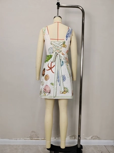 White mini dress with ocean print and lace-up corset back featuring a large bow detail