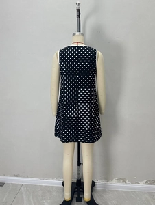 Back view of an elegant black sleeveless polka dot mini dress with a round neck