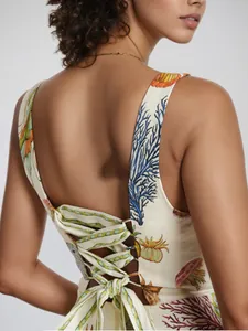 Detail of cross back straps and large bow on a white floral print mini summer dress