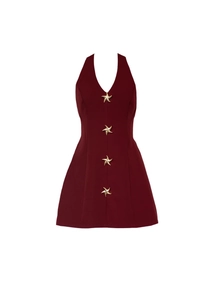 Detail of burgundy halter mini dress with four golden starfish applique ornaments