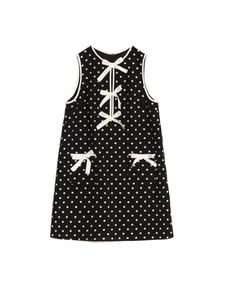 Detailed view of the white bows and polka dot pattern on the sleeveless mini dress
