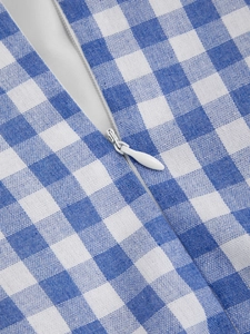 Close-up of invisible zipper detail on blue and white gingham cotton dress fabric