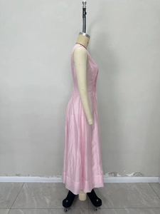 Pink sleeveless maxi dress with elegant pleats and cinched waist on mannequin