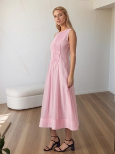 Detail view of pink sleeveless maxi dress with elegant vertical pleats and soft texture