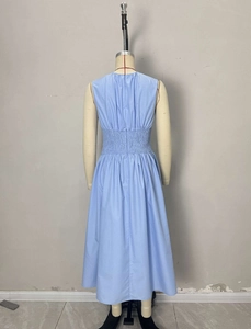 Detail view of the back zipper and pleated waist on the light blue sleeveless dress