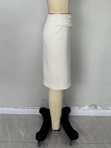 Detail of elegant white midi skirt featuring stylish waist pleats and side split