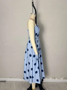 Vue latérale détaillée d'une robe sans manches à pois bleus sur un mannequin de couture