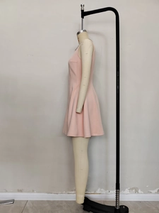 Detail of the elegant pale pink sleeveless dress featuring a sequined diamond neckline