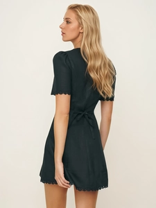 Women's black short sleeve mini dress with lace trim and bow-tie back waist design