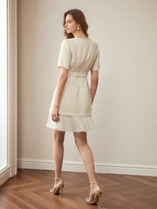 Elegant apricot tweed short sleeve mini dress with pleated hem and belted waist detail