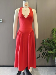 Detail view of red V-neck halter dress featuring ruched high-waist and pleated A-line skirt