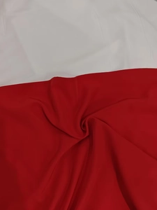 Detailed view of the red chiffon fabric texture with elegant drapes and folds