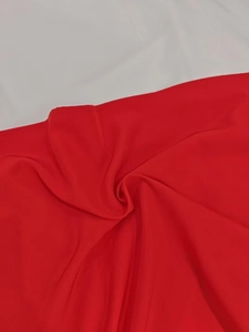 Detailed view of high-quality red fabric texture with precise stitching and subtle sheen
