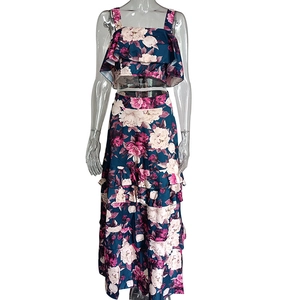 Detail of floral print tiered maxi skirt and ruffled camisole top two-piece set