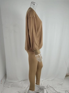 Detail view of khaki knit lounge set featuring round neck top and slim pants on mannequin