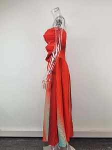 Detail of red and blue gradient tube dress showing rich pleated texture and chiffon fabric