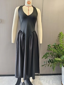 Close-up of deep V-neck halter design and gathered waist on this black maxi dress