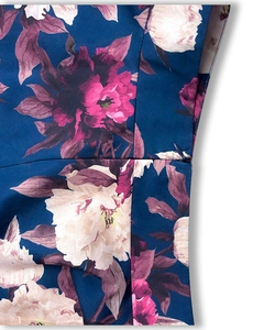 Macro detail of high-quality invisible side zipper on floral print tiered maxi skirt