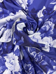 Detailed macro view of the blue floral print chiffon fabric with neat overlock edges