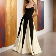 Close-up of the elegant black and white split hem dress in a sophisticated gallery setting