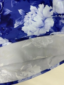 Detailed macro view of the floral print fabric with high-quality flat seam stitching edge