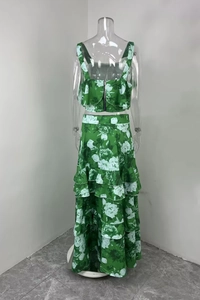 Detail of green floral two-piece set featuring back zipper on crop top and tiered maxi skirt