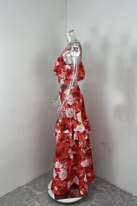 Detail view of red floral printed two-piece set with ruffled top and tiered maxi skirt
