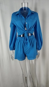 Detail of royal blue two-piece set featuring a button-down shirt and elastic waist shorts