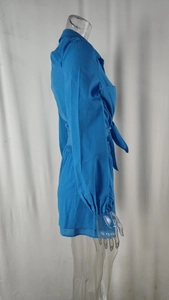 Detail view of bright blue waist-tie shirt with cuffed sleeves and matching shorts