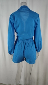 Rear view of blue two-piece set featuring long-sleeved shirt and elastic high-waist shorts