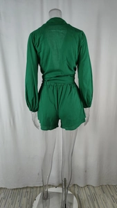 Rear view of bright green wrap-around shirt with tie waist and high-waisted shorts set