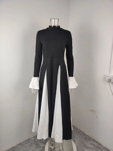 Detail of flared bell sleeves and white accordion pleats on this slimming bicolor maxi dress