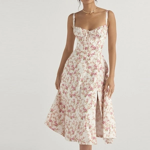 Detail of floral midi dress with sweetheart neckline, dainty bow, and side leg slit