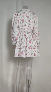 Detail view of pink rose floral dress back showing white lace trim and elastic cuffs