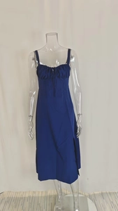 Detail of royal blue dress showing pleated neckline with a delicate bow tie decoration