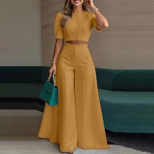 Chic mustard yellow two-piece set featuring short sleeve cropped top and wide-leg trousers