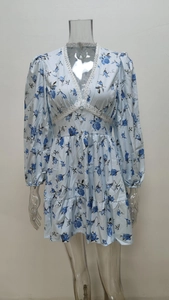 Detail of V-neckline with delicate white lace trim on a floral print mini dress