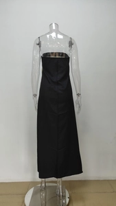 Rear view of black strapless maxi dress with a sleek finish and vertical tailoring