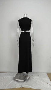 Detail of black cut-out two-piece dress set showing backless design on a transparent model