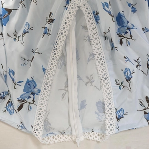 Close-up of invisible zipper and white lace trim on light blue floral chiffon dress