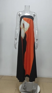 Detailed macro view of the bold abstract geometric pattern on this off-shoulder maxi dress