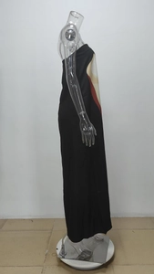 Detail of a black strapless maxi dress featuring vibrant red and yellow artistic color blocks