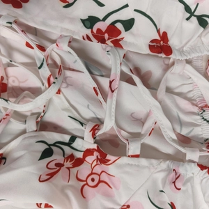 Détail du tissu à fleurs avec cordons croisés blancs et boucles en tissu