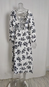 Détail d'une robe longue fleurie avec dos nu à lacets et manches bouffantes élégantes