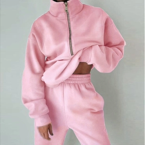 Detail view of pink half-zip sweatshirt and matching high-waist drawstring joggers